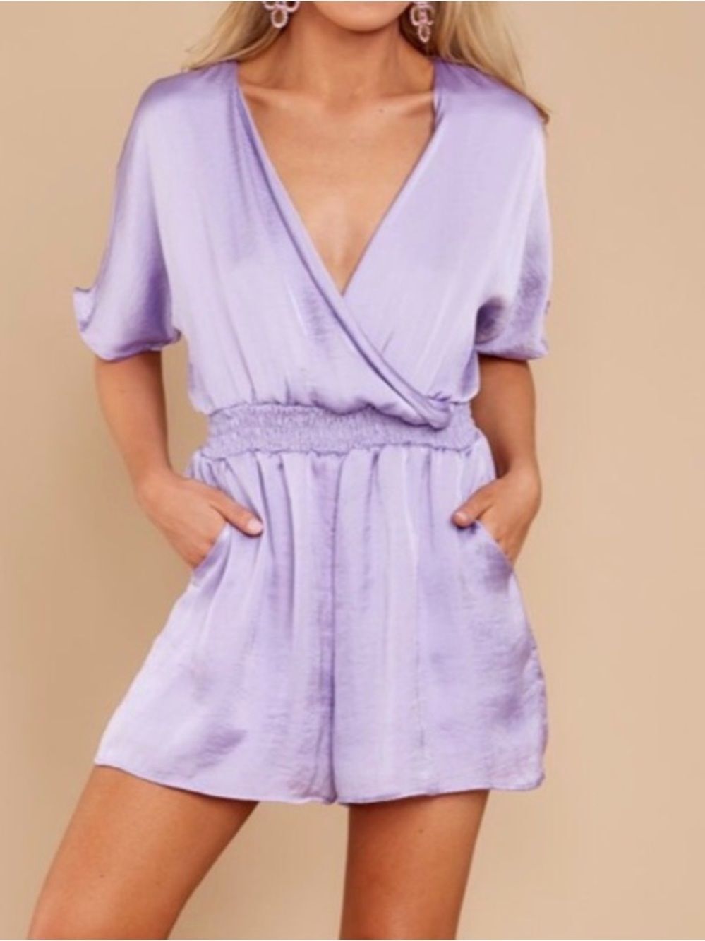 Adrienne lavender romper features a surplice neckline, cinched waist. Size Large